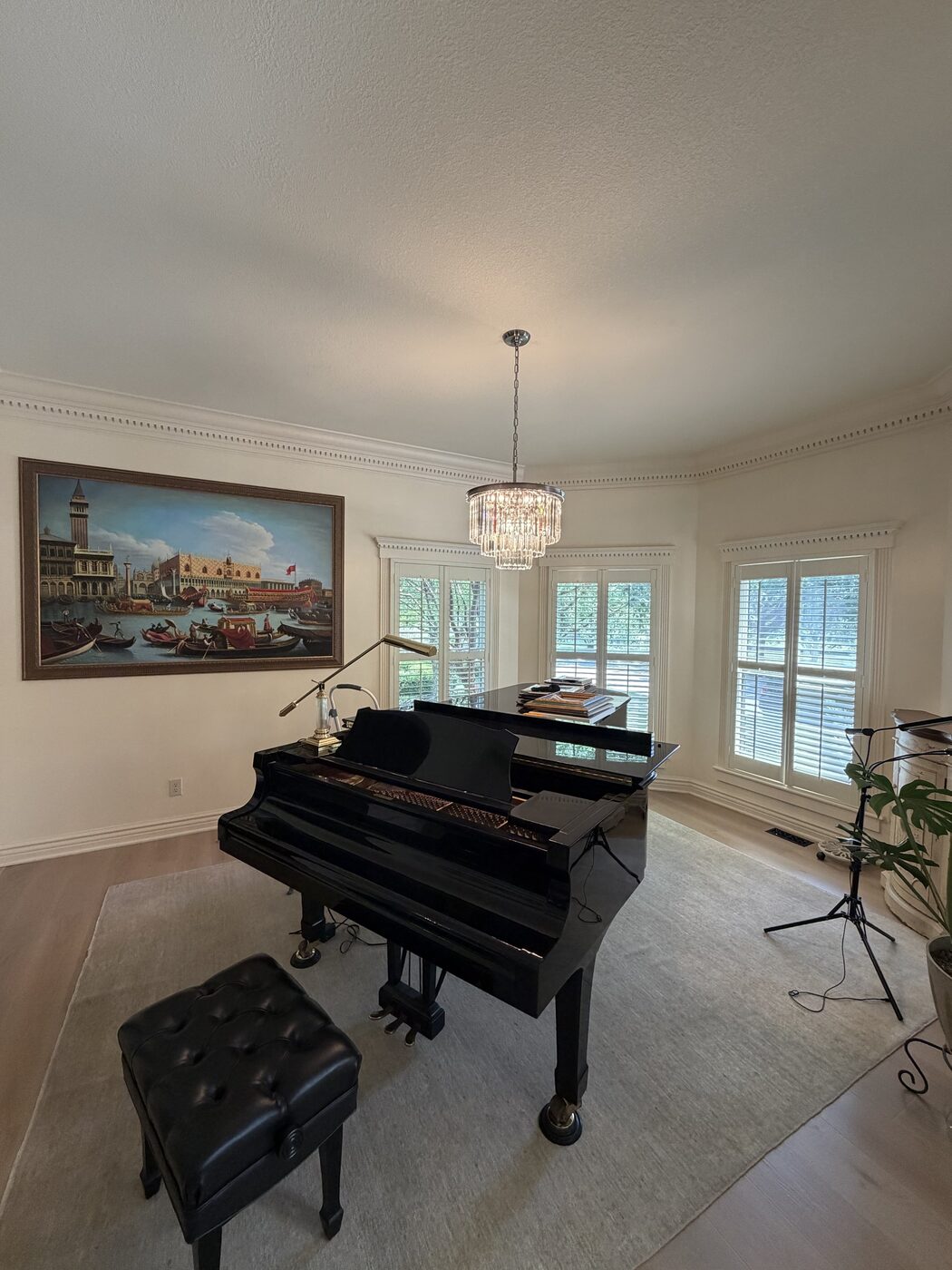 Statement chandelier installed by Wood & Wire in a grand piano room